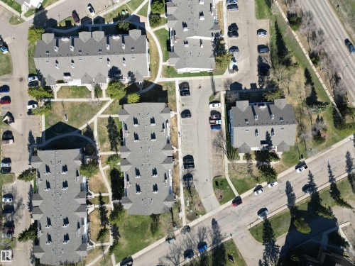 Community of multi-unit buildings featuring pitched roofs and multiple dormers - 5 2204 118 Street, Edmonton, AB - 