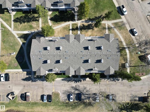 Multi-unit building featuring a gabled roofline with dormers, a shingle roof, and multiple chimneys - 5 2204 118 Street, Edmonton, AB - Outdoor With View