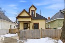 The property features light yellow siding, a dark roof, and a wooden fence along the front - 10927 93 Street Nw, Edmonton, AB  - Outdoor 