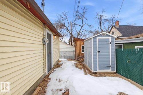 The property features a durable siding exterior and a separate storage shed, providing practical outdoor space - 10927 93 Street Nw, Edmonton, AB - Outdoor With Exterior