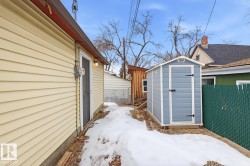 The property features a durable siding exterior and a separate storage shed, providing practical outdoor space - 
