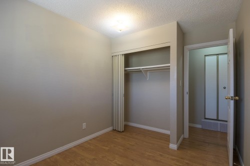 Compact room featuring wood-finish flooring and neutral wall tones - 8039 27 Avenue, Edmonton, AB - Indoor Photo Showing Other Room