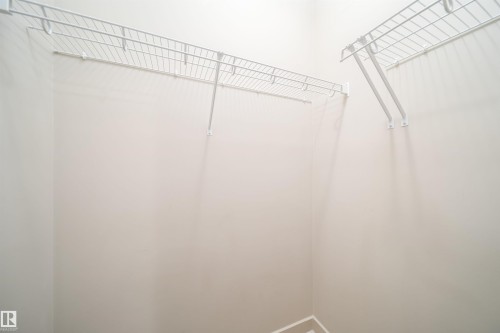 White wire shelving system installed in a neutral-toned closet space - 421 4008 Savaryn Drive, Edmonton, AB - Indoor With Storage