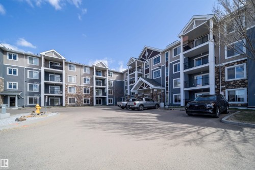 Multi-story building exterior featuring varied siding materials and stone accents - 421 4008 Savaryn Drive, Edmonton, AB - Outdoor With Facade