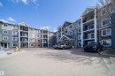 Multi-story building exterior featuring varied siding materials and stone accents - 421 4008 Savaryn Drive, Edmonton, AB  - Outdoor With Facade 