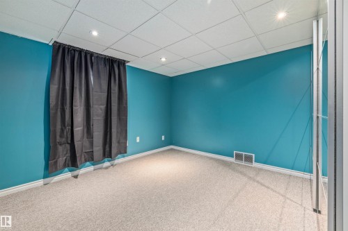 Carpeted room with recessed lighting and blue accent walls - 7927 71 Avenue, Edmonton, AB - Indoor Photo Showing Other Room