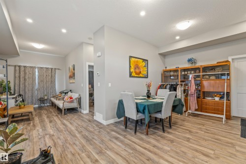 Open-concept living area featuring wood-finish flooring, recessed lighting, and a neutral color palette - 7927 71 Avenue, Edmonton, AB - Indoor