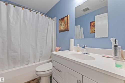 Contemporary bathroom featuring a single white vanity with an integrated sink and chrome faucet - 7927 71 Avenue, Edmonton, AB - Indoor Photo Showing Bathroom