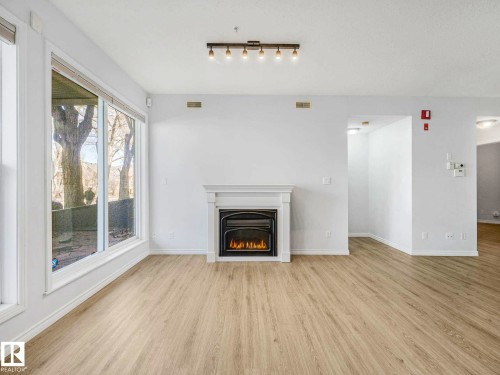 112 11039 83 Avenue, Edmonton, AB - Indoor Photo Showing Living Room With Fireplace