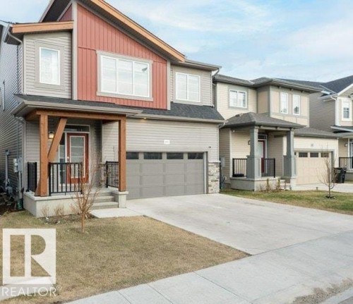 Contemporary two-story residence featuring a striking red and gray facade - 2011 207 Street, Edmonton, AB - Outdoor With Facade