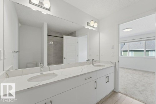 Dual vanity with integrated sinks and white quartz-finish countertops - 2011 207 Street, Edmonton, AB - Indoor Photo Showing Bathroom