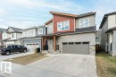 Contemporary two-story residence featuring a multi-textured exterior with horizontal siding, vertical panels, and stone accents - 2011 207 Street, Edmonton, AB  - Outdoor With Facade 