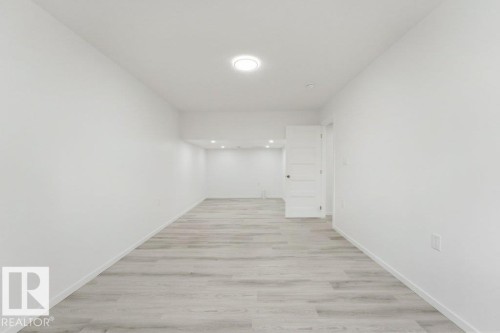Open concept room with light wood-finish flooring - 2011 207 Street, Edmonton, AB - Indoor Photo Showing Other Room