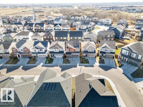 Aerial perspective showcasing a residential street with multiple single-family homes, each featuring individual driveways and attached garages - 2011 207 Street, Edmonton, AB - Outdoor With View