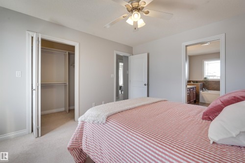 This room features light-colored carpet flooring and a ceiling fan with integrated lighting - 24 Birchmont Drive, Leduc, AB - Indoor Photo Showing Bedroom