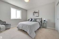 This room features light-colored carpeting, a window providing natural light, and a light-colored ceiling - 