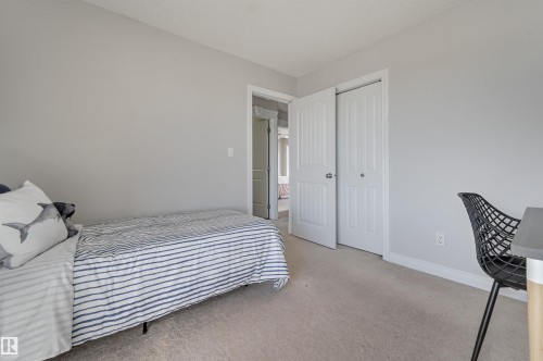 The room features light gray walls and beige carpeting, providing a neutral palette - 24 Birchmont Drive, Leduc, AB - Indoor Photo Showing Bedroom