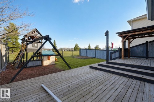 Spacious wood-finish deck featuring a multi-tiered design and a built-in pergola - 24 Birchmont Drive, Leduc, AB - Outdoor With Deck Patio Veranda