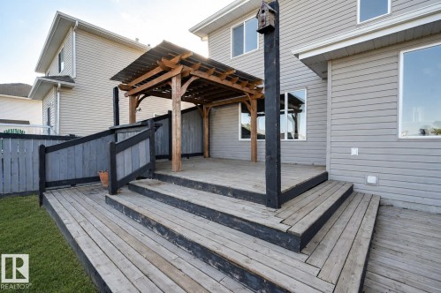 Multi-level wooden deck with steps and a partially covered pergola - 24 Birchmont Drive, Leduc, AB - Outdoor With Deck Patio Veranda