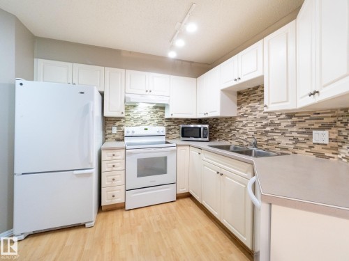 205 11716 100 Avenue, Edmonton, AB - Indoor Photo Showing Kitchen With Double Sink