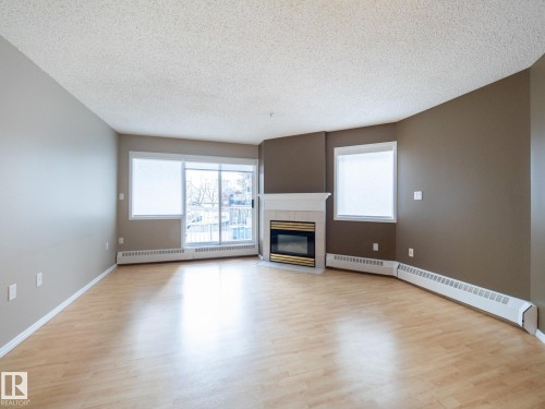 205 11716 100 Avenue, Edmonton, AB - Indoor Photo Showing Living Room With Fireplace
