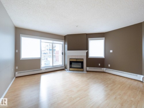 205 11716 100 Avenue, Edmonton, AB - Indoor Photo Showing Living Room With Fireplace