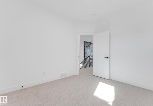 White interior room with light-colored carpet flooring - 4727 17 Avenue Sw, Edmonton, AB - Indoor Photo Showing Other Room