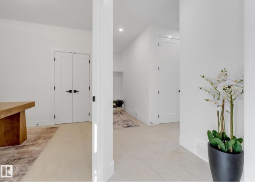 Hallway featuring light-toned flooring, recessed lighting, and white walls - 4727 17 Avenue Sw, Edmonton, AB - Indoor Photo Showing Other Room