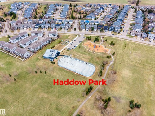 Aerial view showcasing the surrounding neighborhood, featuring residential properties, a recreational building, and a playground - 2340 Hagen Link, Edmonton, AB - Outdoor With View