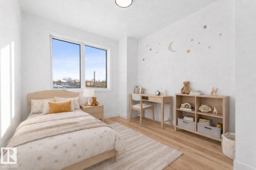 Bedroom with light wood flooring, a large window, and light-colored walls - 11021 132 Street, Edmonton, AB - Indoor Photo Showing Bedroom
