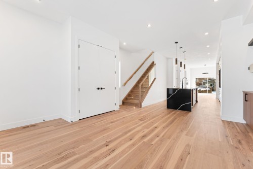 Open concept living area featuring light-toned hardwood flooring, white walls, and recessed lighting - 11021 132 Street, Edmonton, AB - Indoor Photo Showing Other Room
