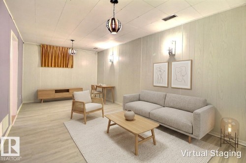 Finished lower level featuring wood-finish flooring, light-toned vertical paneling, and ceiling-mounted light fixtures - 9512 134 Avenue, Edmonton, AB - Indoor