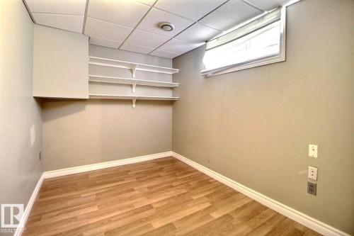 Versatile room featuring wood-finish flooring, a drop ceiling, and a built-in window - 9512 134 Avenue, Edmonton, AB - Indoor Photo Showing Other Room