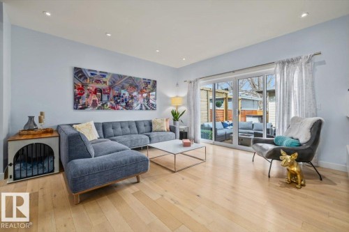 Light wood-finish flooring extending throughout the space - 11245 64 Street, Edmonton, AB - Indoor Photo Showing Living Room