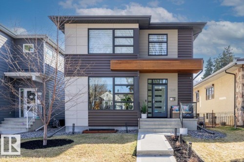 Modern facade featuring horizontal siding, light-toned panels, and a wood-finish accent - 11245 64 Street, Edmonton, AB - Outdoor