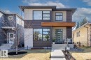 Modern facade featuring horizontal siding, light-toned panels, and a wood-finish accent - 11245 64 Street, Edmonton, AB  - Outdoor 