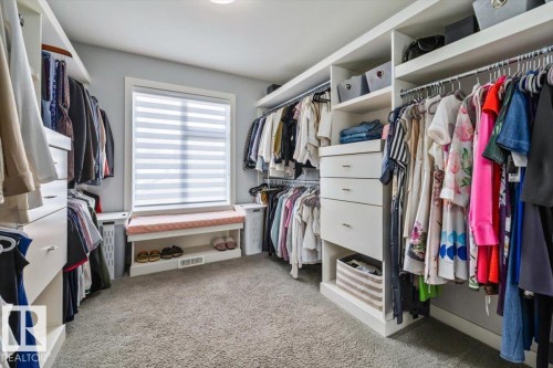 Custom closet system featuring built-in shelving and hanging rods - 11245 64 Street, Edmonton, AB - Indoor With Storage