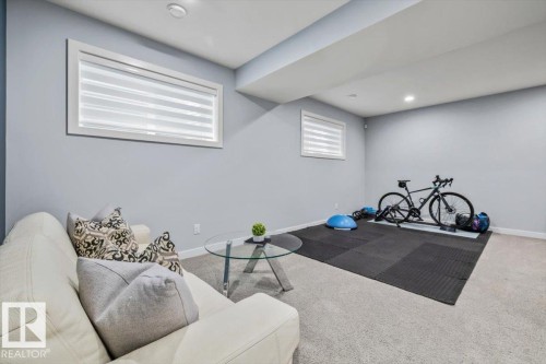 Recessed lighting illuminates this versatile space featuring light gray walls, white trim, and low-profile horizontal windows - 11245 64 Street, Edmonton, AB - Indoor