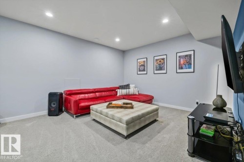 Recessed lighting illuminates this room featuring light gray walls, white trim, and gray carpeting - 11245 64 Street, Edmonton, AB - Indoor