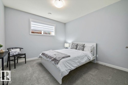 Neutral-toned bedroom with light gray walls and plush gray carpeting - 11245 64 Street, Edmonton, AB - Indoor Photo Showing Bedroom