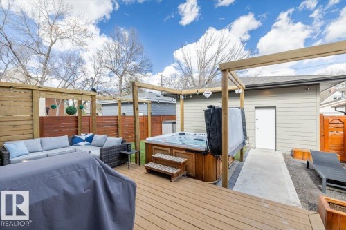 Spacious wood-finish deck with privacy fencing and a sliding glass door entry - 11245 64 Street, Edmonton, AB - Outdoor With Deck Patio Veranda With Exterior