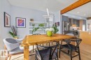 Dining area featuring light wood-finish flooring, a linear chandelier, and built-in shelving - 11245 64 Street, Edmonton, AB  - Indoor Photo Showing Other Room 