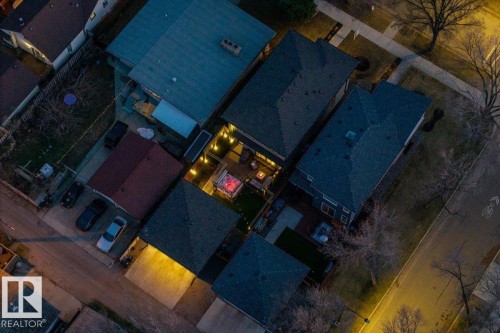Aerial perspective showcasing multiple residential properties with varied roofing materials - 11245 64 Street, Edmonton, AB - Outdoor With View