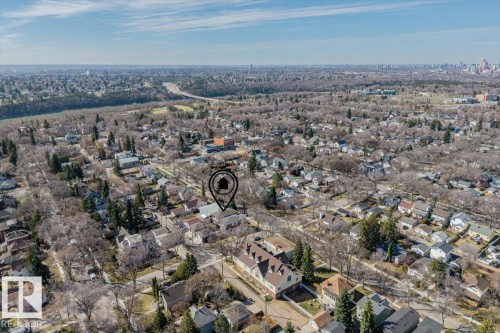 Aerial perspective of a residential area with a prominent river valley in the distance - 11245 64 Street, Edmonton, AB - Outdoor With View