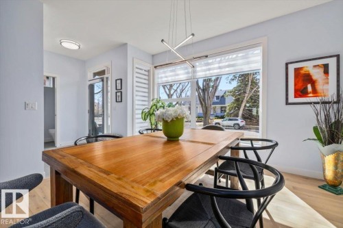 Open dining area featuring wood-finish flooring and light-toned walls - 11245 64 Street, Edmonton, AB - Indoor