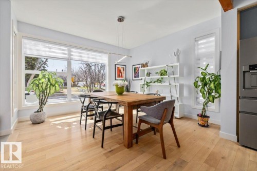 Bright dining area featuring light wood-finish flooring - 11245 64 Street, Edmonton, AB - Indoor Photo Showing Dining Room