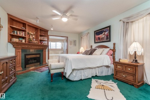 687 Meadowview Drive, Sherwood Park, AB - Indoor Photo Showing Bedroom With Fireplace