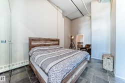 Open room featuring dark slate tile flooring and exposed industrial-style ceiling elements - 