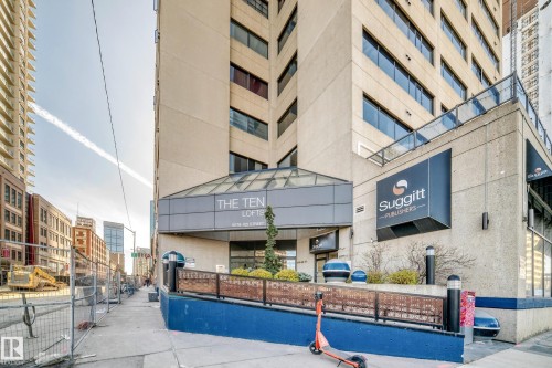 Multistory building with a glass-covered entryway, concrete facade, extensive window lines, and a ramp entrance - 1003 10179 105 Street Nw, Edmonton, AB - Outdoor