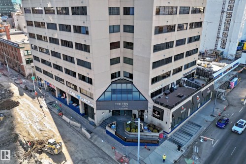 Multi-story commercial building featuring a prominent glass-enclosed entrance vestibule - 1003 10179 105 Street Nw, Edmonton, AB - Outdoor